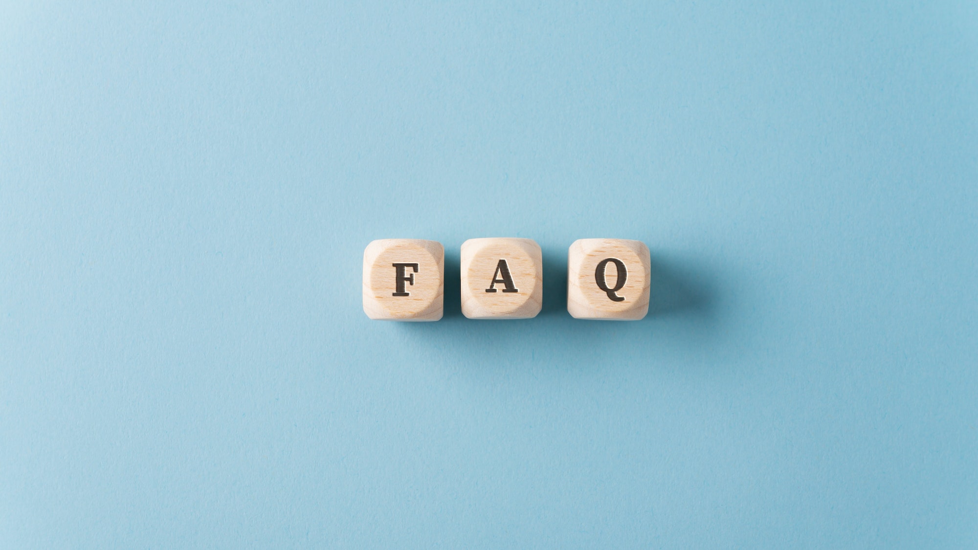 FAQ sign over light blue background